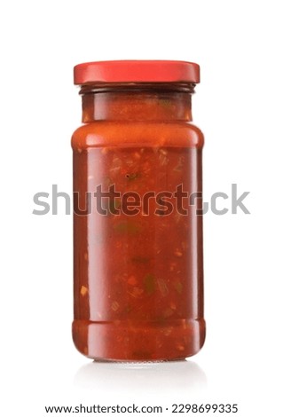Glass jar with taco nachos salsa hot dip sauce on white.