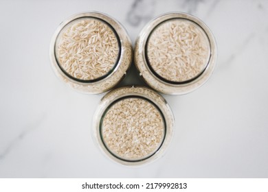 Glass Jar With White Rice Of Different Varieties Including Jasmine Basmati And Sushi Rice, Healthy Pantry Ingredients And Staples