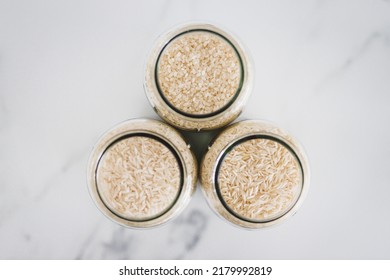 Glass Jar With White Rice Of Different Varieties Including Jasmine Basmati And Sushi Rice, Healthy Pantry Ingredients And Staples