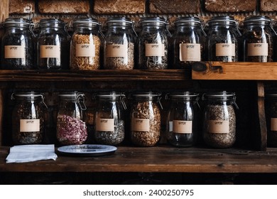 Glass Jars of Assorted Organic Freeze-Dried Foods on Wooden Shelf. Glass jars filled with various dried fruit, Raspberries, herbs and seeds, showcasing an organized pantry setup. - Powered by Shutterstock