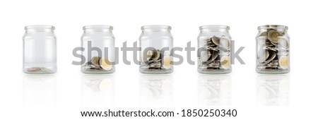 Glass jars with coins like diagram, savings concept. White isolated background