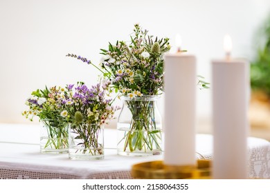 Glass Jars Containing Delicate Wildflowers On The Altar Of A Catholic Church. Wedding Decorations. 