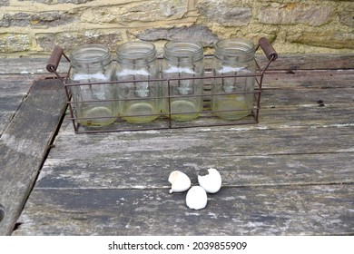 Glass Jars And Egg Shell On Wooden Table.