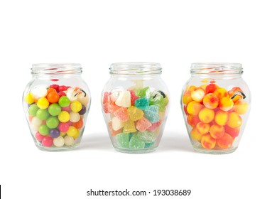 Glass jars filled with different colorful candies 