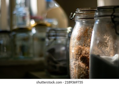 Glass jars full of provisions in a country pantry. Jars and tubs of all shapes and sizes in a windowed country larder. Home made food stuffs and supplies. Country cottage rustic cooking. Fresh food. - Shutterstock ID 2189369735
