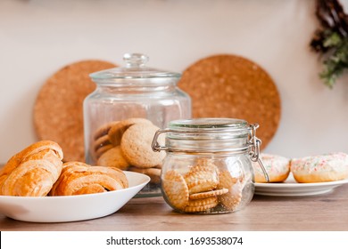 Glass Jars With Homemade Cookies. Crumbled Cookies On The Kitchen Table. Homemade Cakes, Shortbread And Biscuit Dough. Food At Home. Chocolate Cake