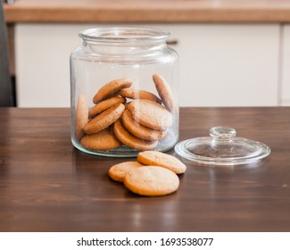 Glass Jars With Homemade Cookies. Crumbled Cookies On The Kitchen Table. Homemade Cakes, Shortbread And Biscuit Dough. Food At Home. Chocolate Cake