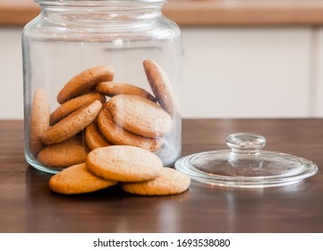 Glass Jars With Homemade Cookies. Crumbled Cookies On The Kitchen Table. Homemade Cakes, Shortbread And Biscuit Dough. Food At Home. Chocolate Cake