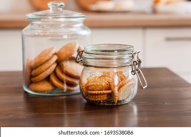 Glass Jars With Homemade Cookies. Crumbled Cookies On The Kitchen Table. Homemade Cakes, Shortbread And Biscuit Dough. Food At Home. Chocolate Cake