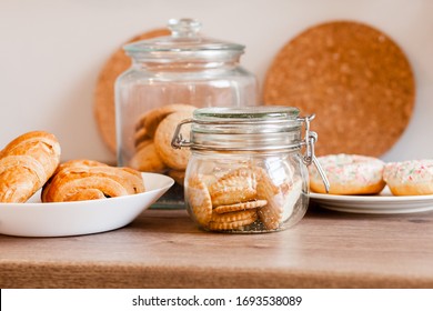 Glass Jars With Homemade Cookies. Crumbled Cookies On The Kitchen Table. Homemade Cakes, Shortbread And Biscuit Dough. Food At Home. Chocolate Cake