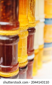 Glass jars with honey on the market - a variety of honey varieties in different shades and thicknesses