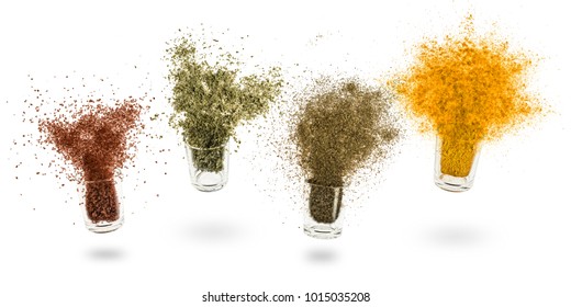 glass jars with various spices flying on white background - Shutterstock ID 1015035208