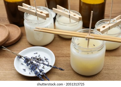 Glass Jars With Wax On Wooden Table. Handmade Candles