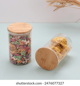 glass jars with wooden lids on blue background. Variety of colorful grain, Farfalle in a glass jar isolated on a white background. High quality photo, Fusilli pasta in a glass jar,  - Powered by Shutterstock