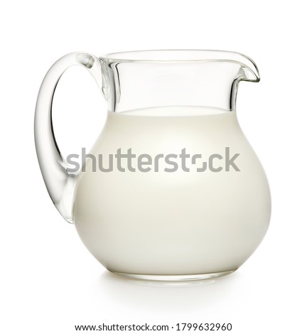 Glass jug of milk isolated on white background