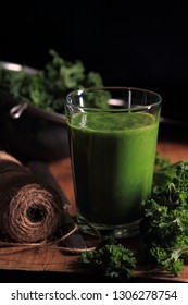 Glass with kale smoothie on a dark background