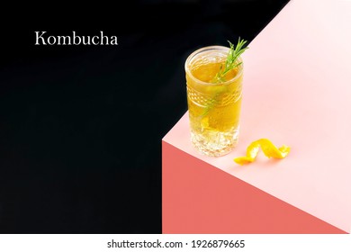 A Glass Of Kombucha Cocktail With Ice And A Sprig Of Rosemary