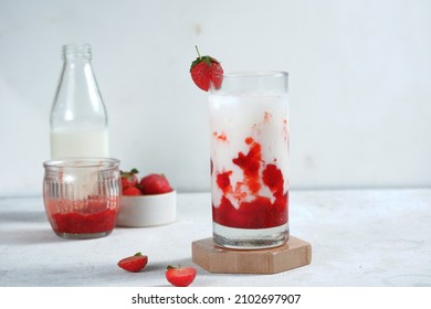 a glass of korean strawberry milk and berries