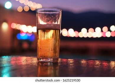 Glass Of Lager Beer In The Rooftop Restaurant At Night