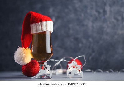 A Glass Of Lager Lager In Santa's Christmas Red Hat Copy Space