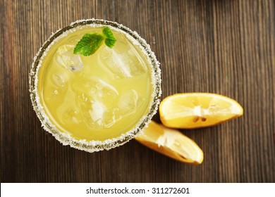 Glass Of Lemon Juice On Wooden Table, Top View