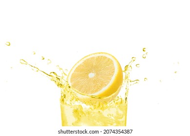 Glass of lemon juice splashing with fresh lemon fruit isolated on white background. 