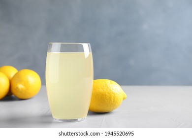 Glass Of Lemonade And Fresh Fruits On Light Table. Space For Text