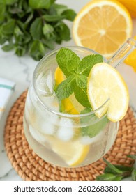 Glass of lemonade with fresh mint. Refreshing homemade iced tea.