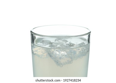 Glass of lemonade with ice cubes isolated on white background