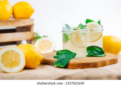 Glass with lemonade with lemon and mint. Summer refreshing drink. Fresh homemade lemonade.