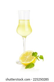 Glass Of Limoncello Liqueur With Half Lemon And Mint Leaf Isolated On White Background