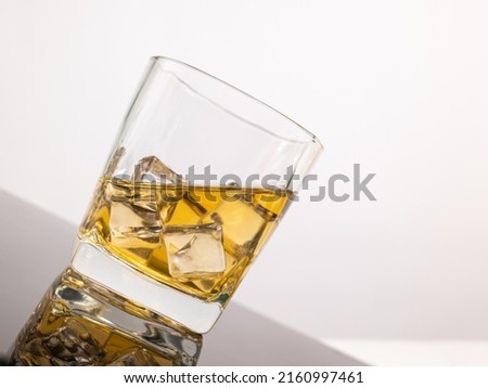 glass for liquor Translucent elements made of glass are placed on a tilted table. empty objects isolated on white background