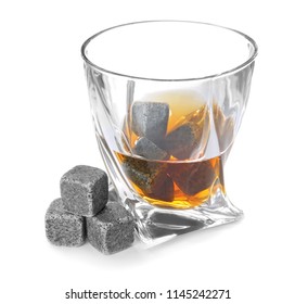 Glass with liquor and whiskey stones on white background