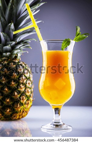 Glass of long drink based on rum, pineapple and orange juice