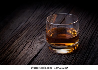 Glass of luxury single malt whiskey. Drink concept photography taken on old wooden table.