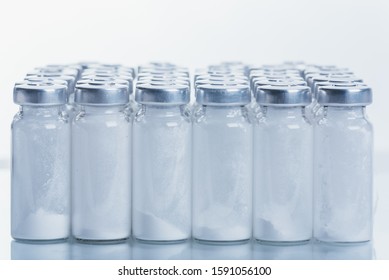 Glass medical ampoule vial for injection. Medicine is dry white drug penicillin powder or liquid with of aqueous solution in ampulla. Close up. Bottles ampule with aluminum cap on backgrounds gray. - Shutterstock ID 1591056100