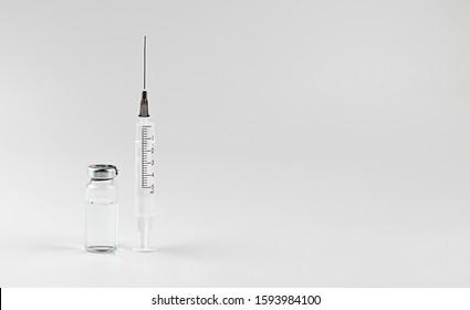 Glass Medicine Vial jar botox with medical Syringe pattern on white background. The concept of medicine, beautician, drugs, disease prevention, virus, flu, covid-19. Copy space.