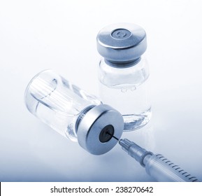 Glass Medicine Vials and botox hualuronic collagen and flu syringe. Tinted image.