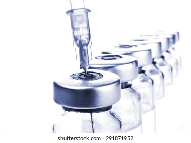 Glass Medicine Vials and botox hualuronic collagen or flu syringe. Tinted image.