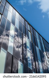 Glass And Metal Building With Reflective Clouds