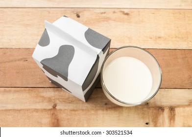 Glass Of Milk, A Carton Of Milk On Wooden Table.
