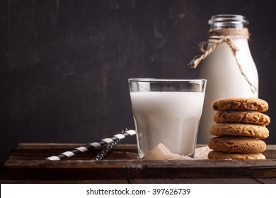 Glass of milk and chocolate chip cookies on wooden background - Powered by Shutterstock