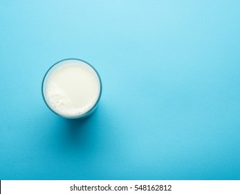 Glass Of Milk On The Blue Background. Top View.