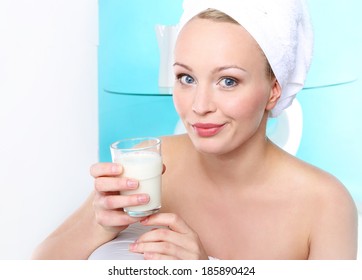 Glass Of Milk For Strong Bones  .Portrait Of A Young Woman Sitting On The Sofa With A Glass Of Milk .