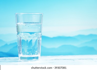 Glass Of Mineral Water Against Mountain Landscape