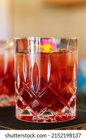 Glass Of Mocktail With Tiny Flowers. Ideas About Mocktail Recipe With Edible Flowers.