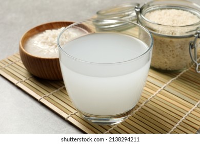 Glass with natural rice water on bamboo mat - Shutterstock ID 2138294211