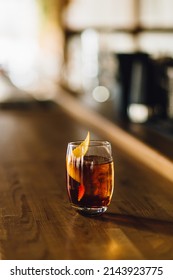 A Glass Of Negroni Cocktail On A Bar Counter At The Restaurant Daytime On A Blurred Background 