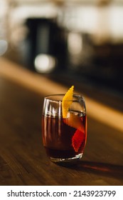 A Glass Of Negroni Cocktail On A Bar Counter At The Restaurant Daytime On A Blurred Background 