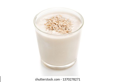 Glass Of Oat Milk And Grains On Top Bowl Isolated On White Background